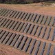 Flying over large solar panels at solar farm at sunny summer day - VideoHive Item for Sale