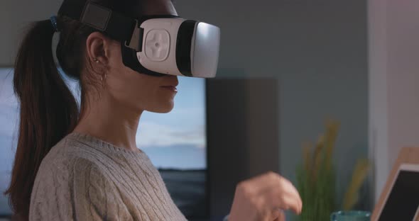 Woman wearing a VR headset and enjoying virtual reality