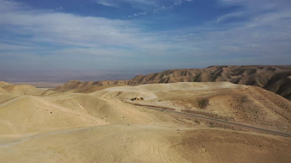 fly over sand dunes and zoom at an isolated ancient ruin in the desert, Israel alt
