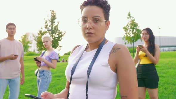 Slow motion young happy multiethnic woman outdoor using smartphone alt