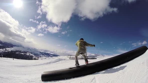 A young man snow boarding. alt
