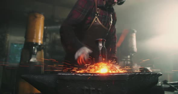 A Blacksmith Works Forging Metal Closeup alt