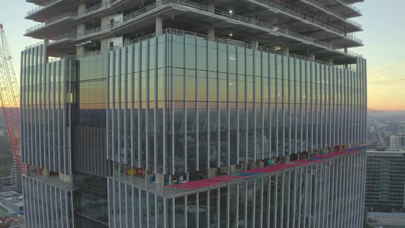 Aerial Side View Of Construction Of Upper Levels Of A Tall Office Building