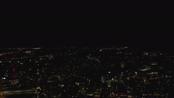 Aerial view of Illuminated city center at night. alt