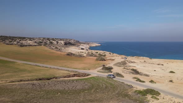 Aerial photography of a car ride against the background of the sea.