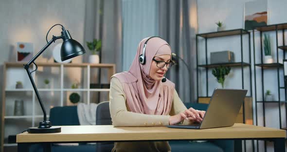 Arabic Woman in Hijab Sitting in front of Computer in Home Office alt