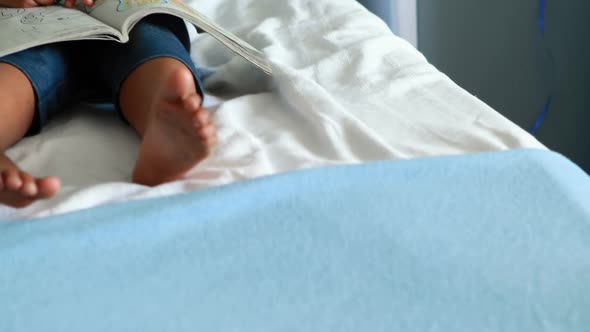 Girl drawing picture in a book alt