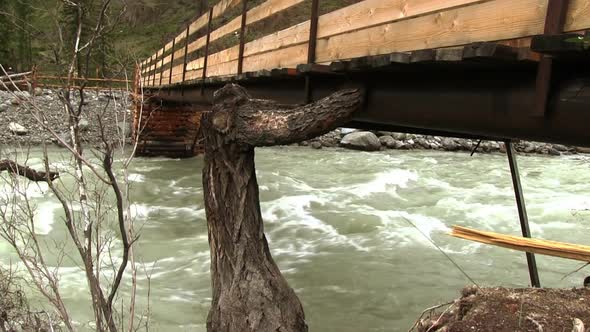 Wooden Bridge Over Mountain River