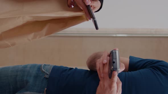 Vertical Video Delivery Man Delivering Food Order Takeaway to Businesswoman in Startup Company alt