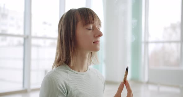 Woman Meditating with Palo Santo Holy Wood Relaxation Zen Practice in Studio alt