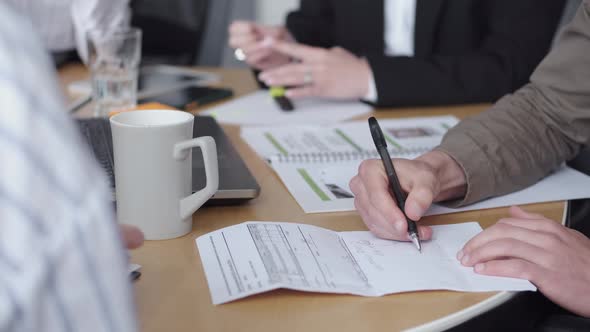 The Papers Are on the Office Table Being Signed By Male Hands alt