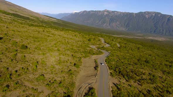Aerial shot tracking a winding road near Osorno, Los Lagos Region, Chile alt