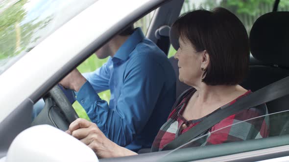 Aged Woman Learning To Drive a Car alt