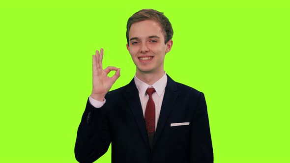 Young Smiling Man in Suit Showing Ok Sign