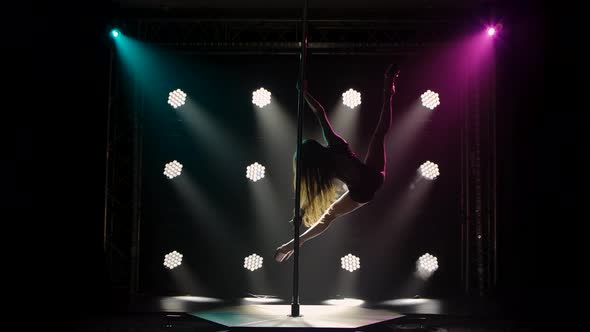 Professional Pole Dancer Performs Tricks While Spinning on a Pole Splitting and Walking in the Air alt
