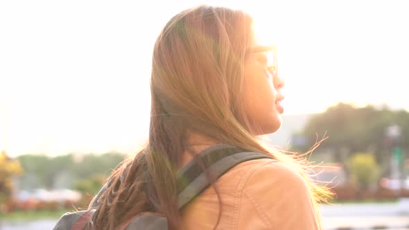 Asian Female Tourist Backpacker Walking on Street During Trip to Bangkok Thailand alt