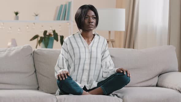 Young Focused African American Woman Sitting in Lotus Position with Closed Eyes Healthy Calm Girl alt