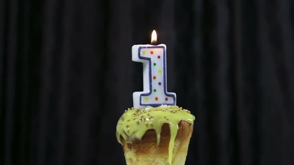 Cupcake with a Burning Candle with the Number 1.