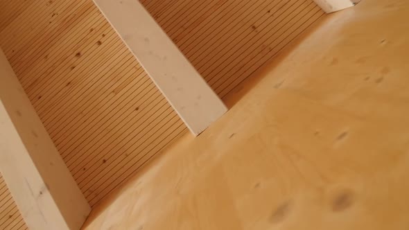 Detail of a wooden wall with a wooden roof in a new residential building construction alt