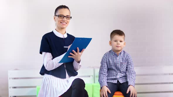 Young Professional Female Psychologist Little Cute Boy Smiling Looking at Camera alt