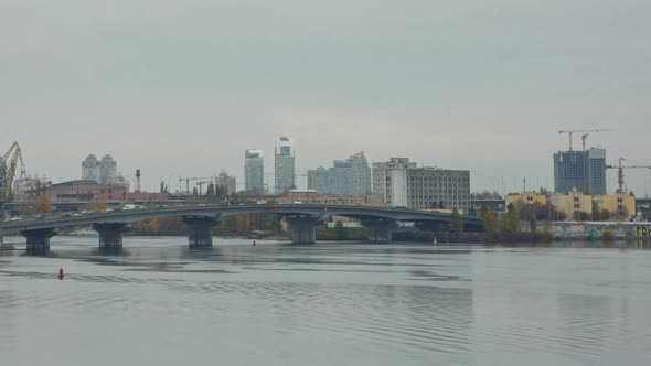 The Bustle Of A Big City Near The River Bank With Bridges, Cloudy Weather, Kiev, Ukraine