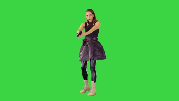 Shootercharacter Girl Gets a Gun Out of Holster and Takes an Aim on a Green Screen Chroma Key