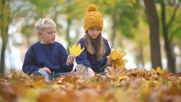 Happy Cute Children Having Fun in the Autumn Park. alt