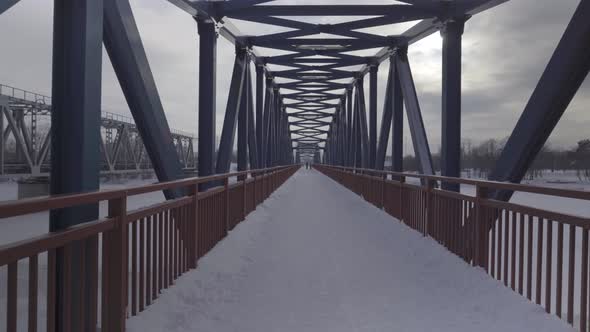 Walk across the bridge over the river Gauja in winter