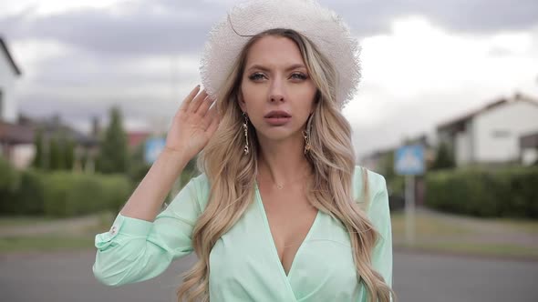 Immaculate Lady in White Hat Looking at Camera