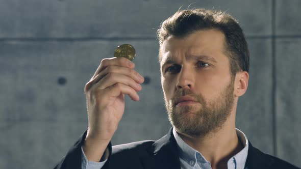 Portrait of Man Holding Bitcoin in His Hand and throw it out alt
