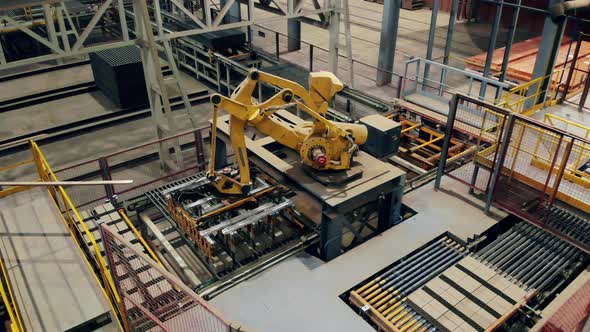 Modern Automated Factory Equipment. Robotic Loader Is Transporting Brick Products alt