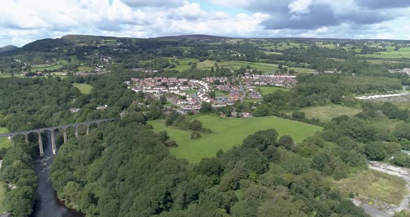 Aerial decent towards Llangollen town towards aqueduct and canal alt