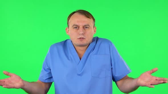 Upset Man Shrugs and Shakes Her Head Negatively. Green Screen alt