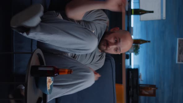 Vertical Video Scared Shocked Astonished Man Looking at Horror Movie at Tv alt