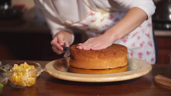 Close Up Shot of a Woman's Hands That Cuts a Freshly Baked Cake Into Pieces alt