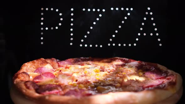 Delicious Fresh Italian Pizza On A Black  Background With The Effect Of Light Inscription Pizza