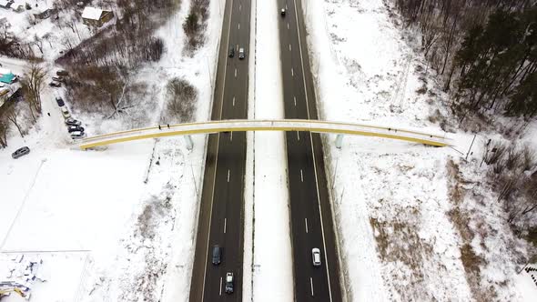 Pedestrian bridge over A1 highway near Kaunas city in winter season, aerial view alt