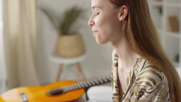 Cheerful Woman Putting on Headphones and Listening to Music alt