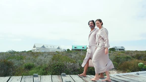 Couple walking on boardwalk alt