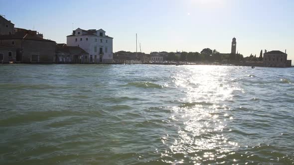 Motorboat Floating on Grand Canal, Sun Reflections on Water, Transportation alt