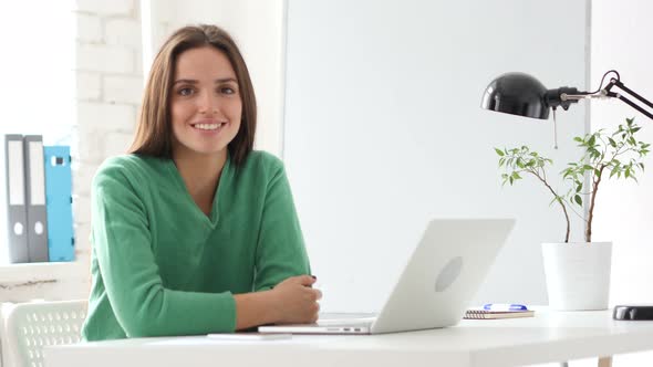 Creative Woman Looking at Camera  in Office alt