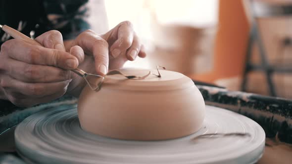 Potter, Craftsman is Working on Pottery Wheel, Rotating the Wheel Fast, Removes Extra Clay