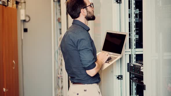 Technician Testing Network Connection. Hardware Updates On Server Room. Engineer Connect Network. alt