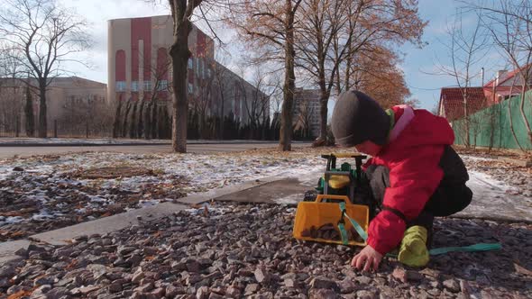 Boy Playing With Stones alt