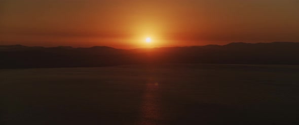 Beautiful landscape with sunset over the big lake and the mountains, Tilting down to up shot alt