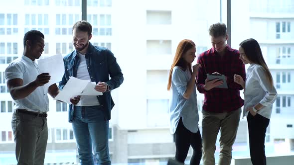 Successful Young Multiethnic Startup Business Team Having Conversation in Modern Boardroom on alt