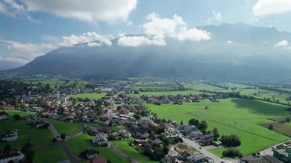 Aerial View of Liechtenstein with Houses on Green Fields in Alps Mountain Valley alt