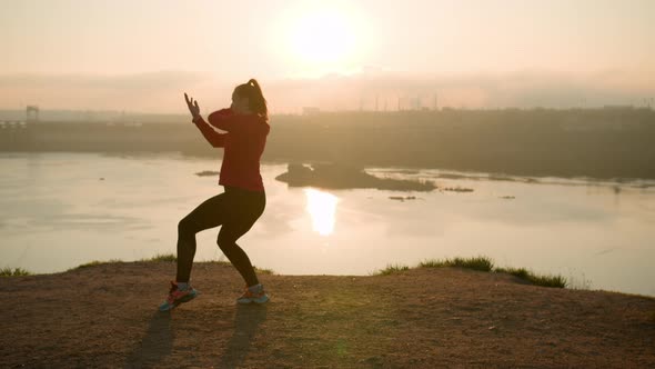 Sporty Woman Practicing Martial Arts Exercises in Nature