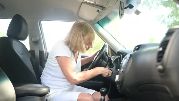Senior Woman Driving Sitting in New Car Wearing Seat Belts Preparing for First Trip Angry Because