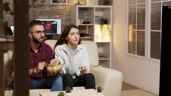 Boyfriend Covers Girlfriend Eyes While Watching a Horror Movie alt